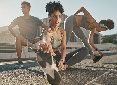 Buy stock photo Fitness, team and friends stretching in city street for exercise run, marathon training run or cardio performance workout. Health commitment, focus and black people warm up while listening to music 