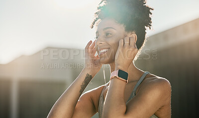 Buy stock photo Fitness, music and black woman doing exercise in city with earphones, smile and ready for training. Workout, running and young female athlete doing sports in town listening to track, audio and radio