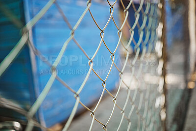 Buy stock photo Steel, iron or metal fence for safety with a blurred background at an outdoor shelter or clinic. Chain link, veterinary and closeup of a wire barrier for security outside with enclosure or barricade.