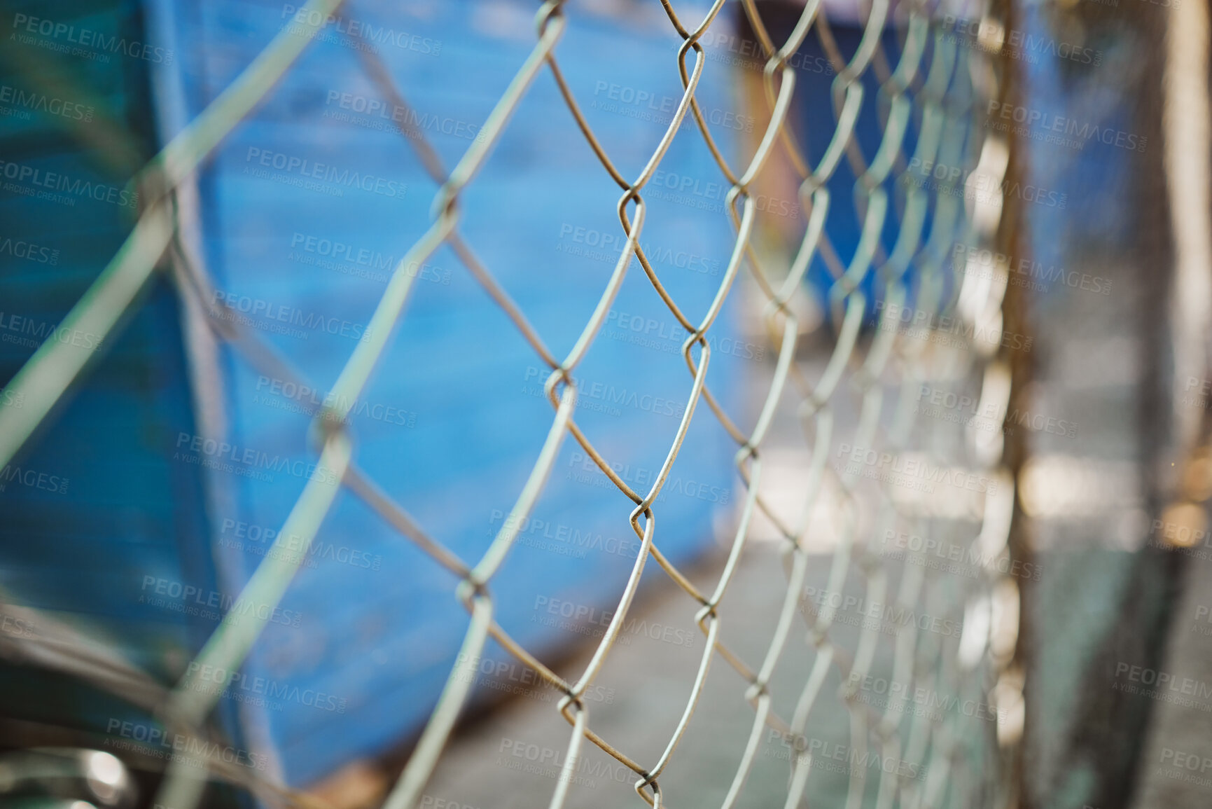 Buy stock photo Steel, iron or metal fence for safety with a blurred background at an outdoor shelter or clinic. Chain link, veterinary and closeup of a wire barrier for security outside with enclosure or barricade.