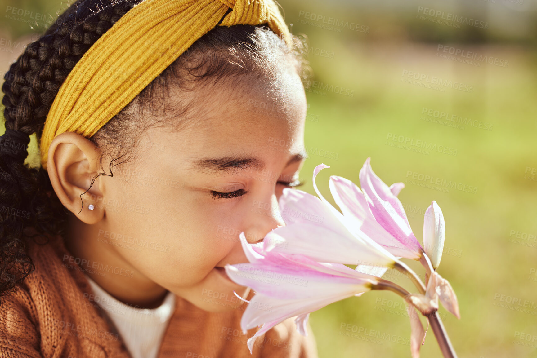 Buy stock photo Nature, beauty and child smell flower in park, enjoying weekend, holiday and vacation in countryside. Peaceful, freedom and young black girl smelling aroma or scent of plant on field in spring time