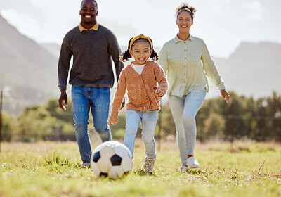 Buy stock photo Happy family, soccer ball and playing on the grass in nature for fun, bonding and active exercise in the outdoors. Mother, father and child enjoying quality family time together with ball on a field