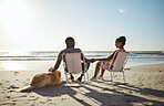 Black couple, dog and sunset beach while on chair to relax on vacation holding hands for love, care and trust by ocean for quality time. Pet with man and woman in healthy marriage on holiday by sea