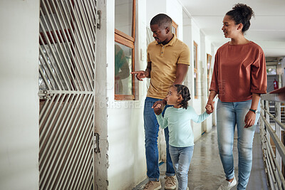 Buy stock photo Black family, animal shelter and planning adoption with mother, father and child walking together inside vet building for charity or volunteer work. Man, woman and girl together at pet ngo center