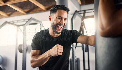 Buy stock photo Boxing gym, fitness and happy athlete boxer punching a training bag in a martial arts studio or club. Happiness of a man in a fight workout and sport exercise with a smile about healthy cardio