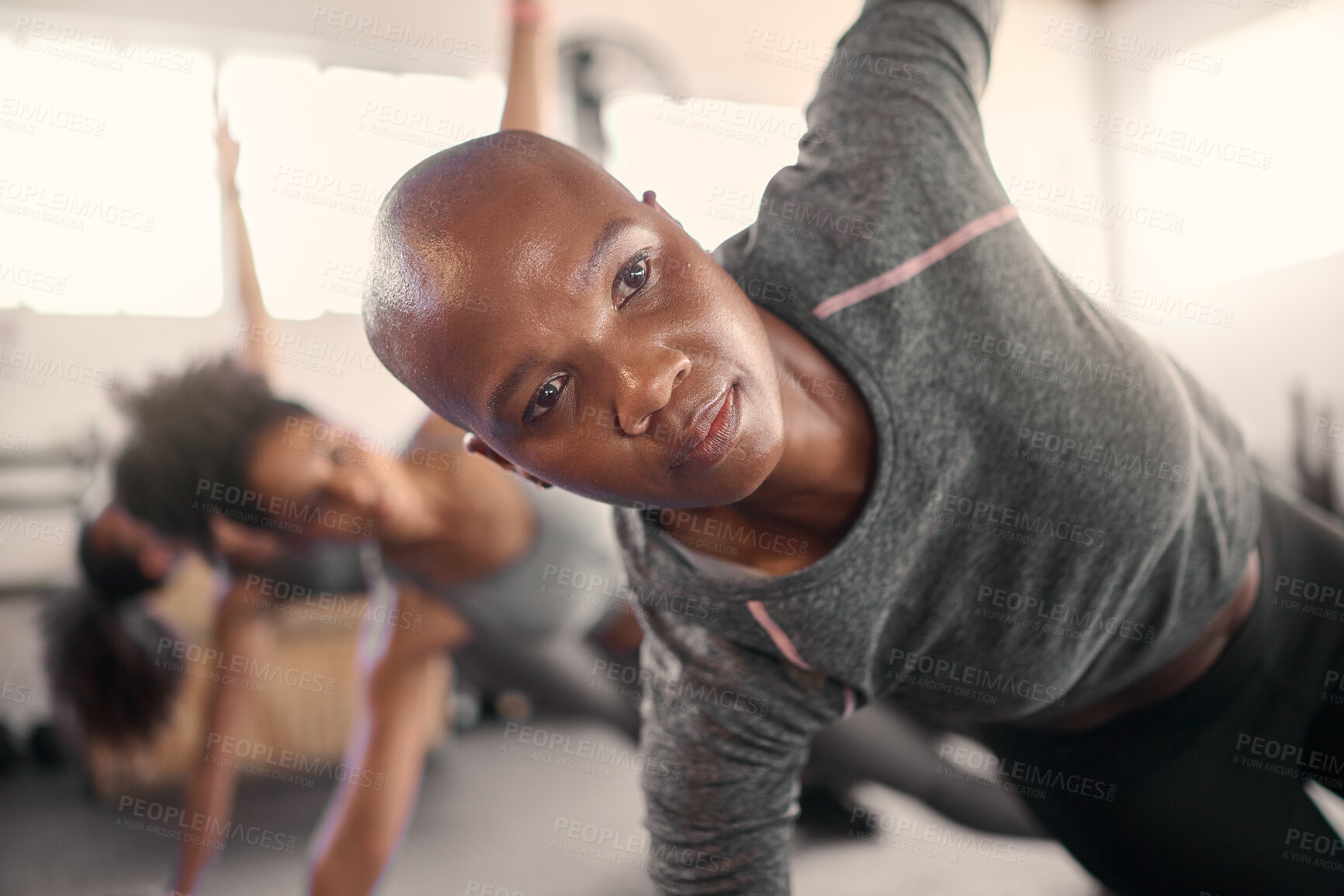 Buy stock photo Fitness class, pilates and black woman focus on balance, wellness and yoga pose in a health studio. Gym training, exercise and workout for peace and healthy sport stretching with women group