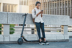 Phone, music and electric scooter with a business black man streaming audio during his commute into work. Mobile, headphones and transport with a male employee typing a text message in an urban town