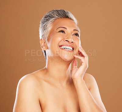 Buy stock photo Face, beauty and antiaging with a senior woman in studio on a brown background thinking about skincare. Idea, luxury and wellness with a mature female posing to promote natural skin treatment