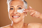 Senior woman, skincare and beauty with a eye patch or collagen mask for a facial with cosmetics and dermatology product for clear and health skin. Face portrait of mature model happy about self care