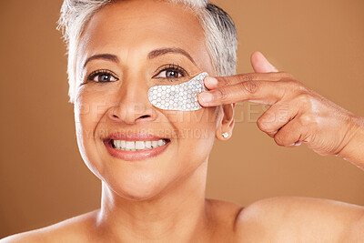 Buy stock photo Senior woman, skincare and beauty with a eye patch or collagen mask for a facial with cosmetics and dermatology product for clear and health skin. Face portrait of mature model happy about self care