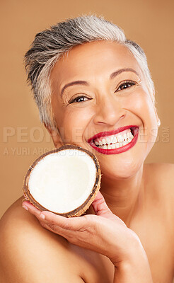 Buy stock photo Senior woman, skincare and coconut in studio for beauty, health and wellness in happy cosmetic portrait. Healthy, elderly black woman and fruit by face for cosmetics, skin and happiness by background