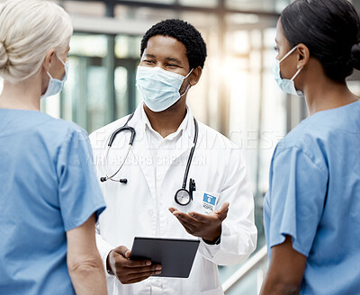 Buy stock photo Face mask, covid and team of doctors with tablet doing research or checking test results in clinic. Medical, hospital and group of healthcare workers in collaboration on mobile device during pandemic