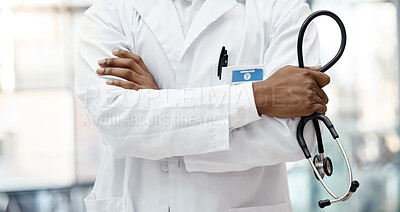 Buy stock photo Healthcare, hospital and hands of doctor with stethoscope standing in clinic with arms crossed. Leadership, support and african american health care worker with medical equipment for innovation