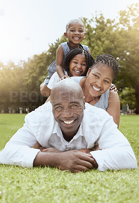 Buy stock photo Family, children and park with a woman, man and daughter siblings lying on grass together outdoor in summer. Portrait, face and pile with a mother, father and kids on a field to relax while bonding