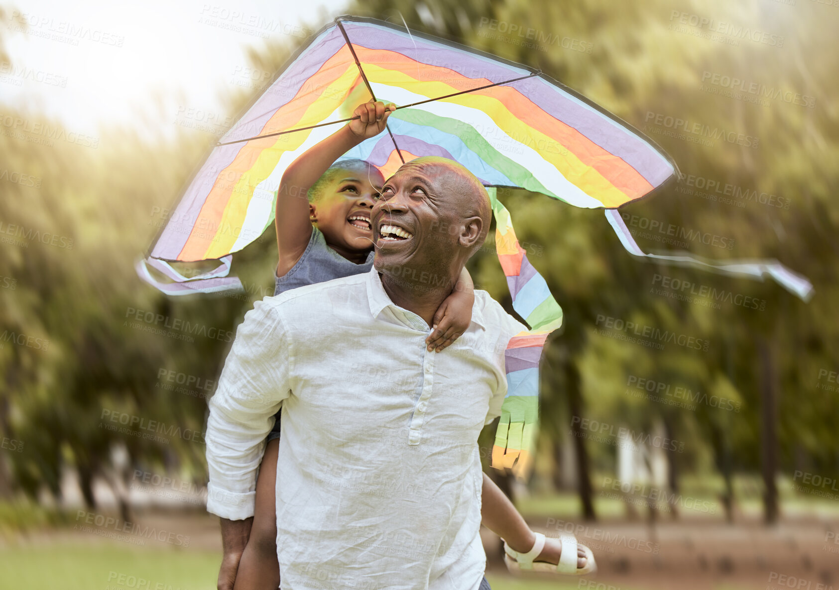 Buy stock photo Father, child and rainbow kite outdoor at a nature park for fun, bonding and trust of life insurance and savings of a black family having fun. Black man giving girl piggy back ride on vacation