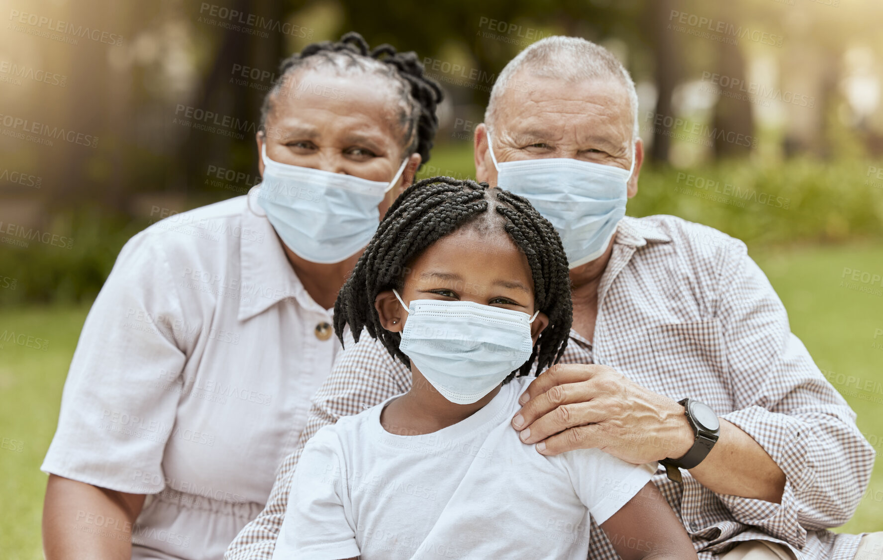 Buy stock photo Family portrait, covid and face mask outdoor at nature park with child and grandparents together on picnic for love, care and summer bonding. Man, woman and girl with covid 19 safety compliance 