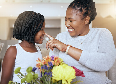 Buy stock photo Love, mother and girl smile, happy and together for bonding, loving and happiness together. Mama, daughter and black family being playful, caring and quality time being cheerful in home with flowers.