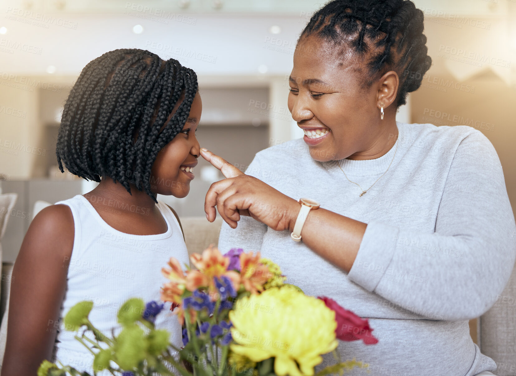Buy stock photo Love, mother and girl smile, happy and together for bonding, loving and happiness together. Mama, daughter and black family being playful, caring and quality time being cheerful in home with flowers.