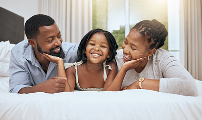 Buy stock photo Black family, girl and smile on bed for portrait with mom, dad and happiness in bonding, care or embrace. Happy family, daughter or child together in bedroom with black woman, quality time and father