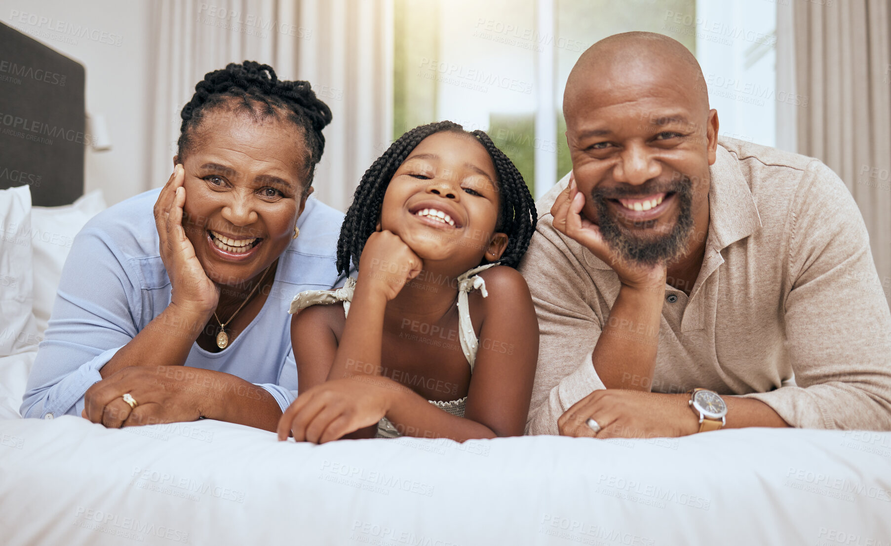 Buy stock photo Love, grandparents and girl on bed, with smile and happy together to relax. Portrait, black family and with daughter in bedroom, bonding and being loving for happiness, quality time and on weekend.