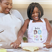 Happy african american girl studying to cook with mother, preparing dough  at kitchen together, woman adding milk t Stock Video Footage by ©Milkos  #474031464