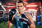 Fitness, sports or motivation man boxer in gym studio with gloves for training, cardio workout or exercise. Focus, mma portrait or male athlete in boxing ring with goal vision, health or fight energy