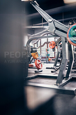 Gym interior, fitness and exercise with gym equipment and weightlifting for body training, health and wellness. Weights, muscle and strong for cardio and endurance with metal and steel for workout.