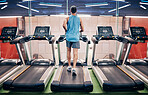 Fitness, man and running on treadmill at the gym for healthy cardio, exercise or weight loss workout. Active sports male runner training or exercising on stationary equipment for a run at health club