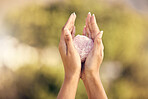 Woman, hands and rose quartz in nature for meditation or occult practice. Crystal, yoga stone or rock for relax, mindfulness and zen healing, spiritual growth and female spirit, chakra or awakening.