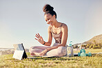 Fitness, woman and tablet call for yoga exercise, training or workout on the grass in the outdoors. Happy female waving for video call on touchscreen in spiritual wellness, zen or lifestyle in nature