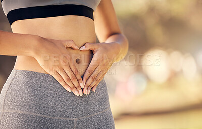 Buy stock photo Weightloss, hands and heart shape on stomach for body positivity during diet, exercise and training. Wellness, health and closeup of woman with self love gesture on tummy while doing outdoor workout.