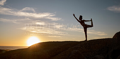 Buy stock photo Woman, silhouette or yoga on sunset beach rocks in relax fitness, training and exercise for mental health, body mobility or wellness. Yogi, pilates or workout at sunrise for zen stretching by ocean