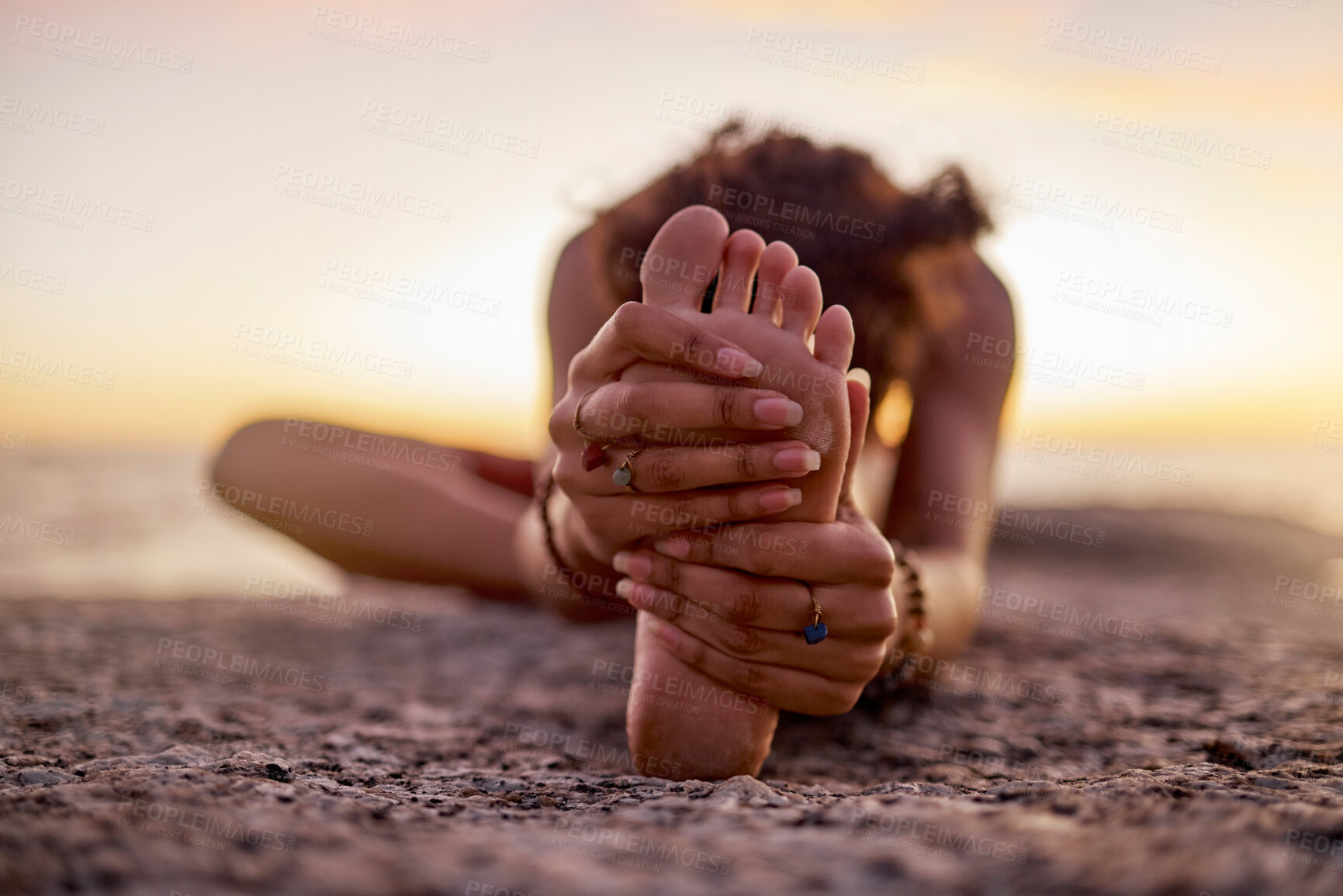 Buy stock photo Stretching, peace and feet of a woman on beach for yoga, training and exercise during sunset. Fitness, sand and legs of girl doing warm up before workout or pilates for wellness and relax by the sea