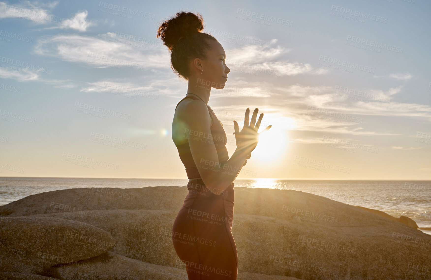 Buy stock photo Yoga, meditation or sunset with woman in peace by the ocean, sea or beach for wellness, zen or chakra balance. Spiritual, health or fitness girl on rock or sand for mindset goal, pilates or workout