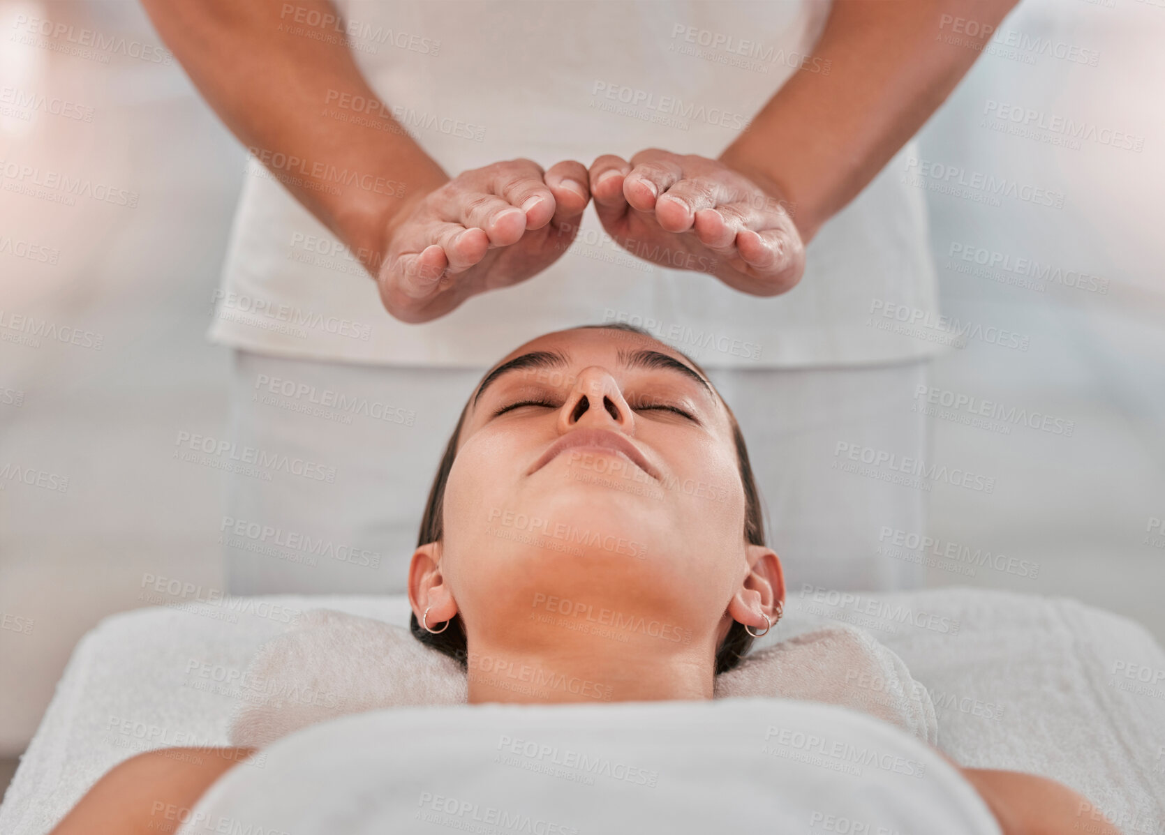 Buy stock photo Relax, health and reiki with woman on spa table for healing energy, zen and alternative medicine. Peace, wellness and luxury with hands of massage therapist for holistic, chakra and spiritual detox