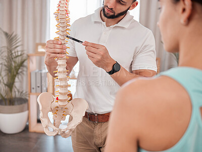 Buy stock photo Chiropractor, spine and anatomy with a medical skeleton for advice and diagnosis of injury during physiotherapy with therapist and patient. Man talking to woman for chiropractic and physical therapy