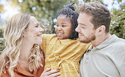 Buy stock photo Adoption, hug and child with parents in a park with love, smile and happy for interracial family. Happiness, natural and African girl kid hugging her mother and father in a backyard or garden