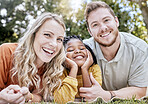 Adoption, mother and father in nature as a happy family relaxing on a picnic bonding in summer holidays. Interracial, portrait and healthy mom with dad enjoying a lovely vacation with a girl child