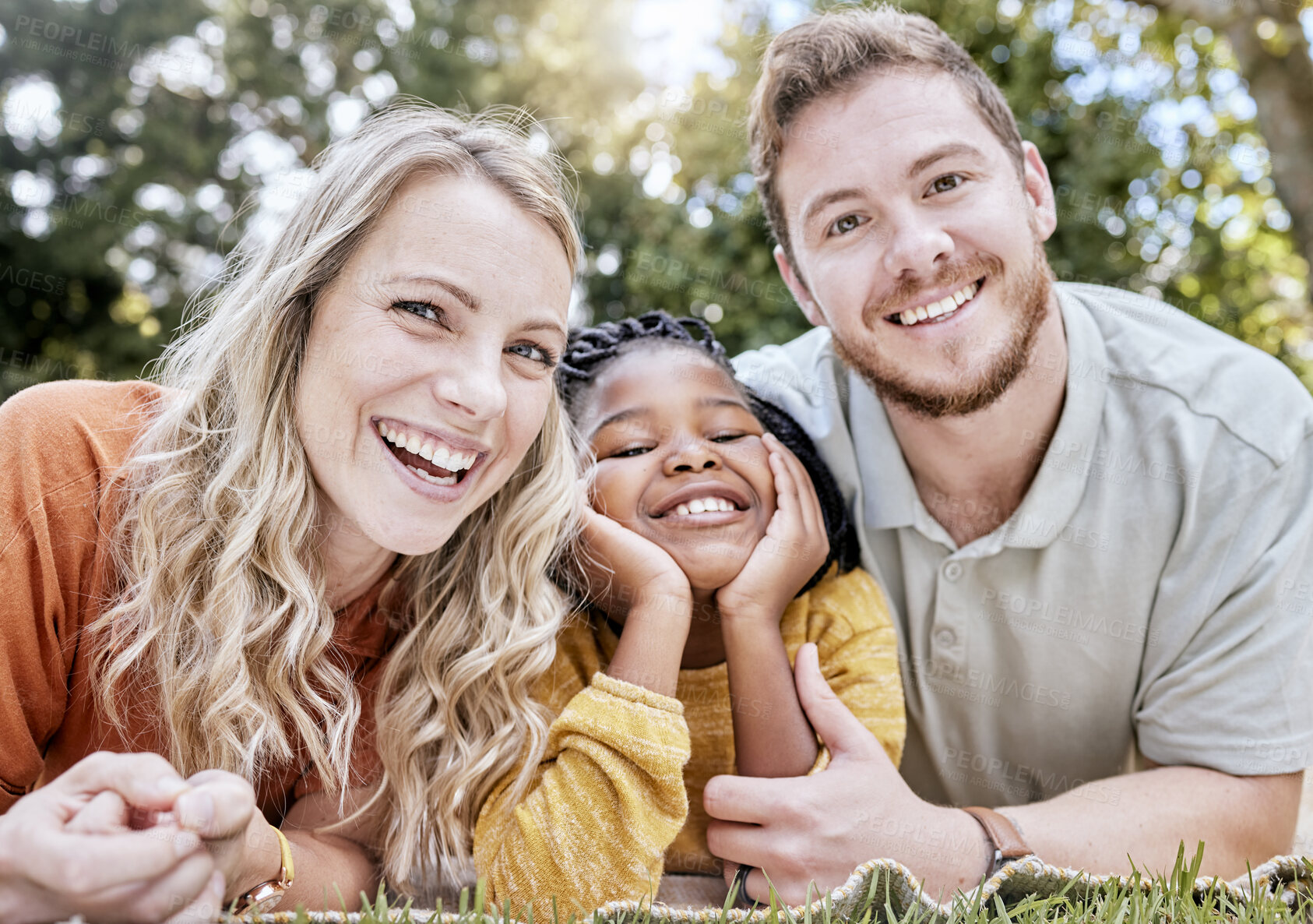 Buy stock photo Adoption, mother and father in nature as a happy family relaxing on a picnic bonding in summer holidays. Interracial, portrait and healthy mom with dad enjoying a lovely vacation with a girl child