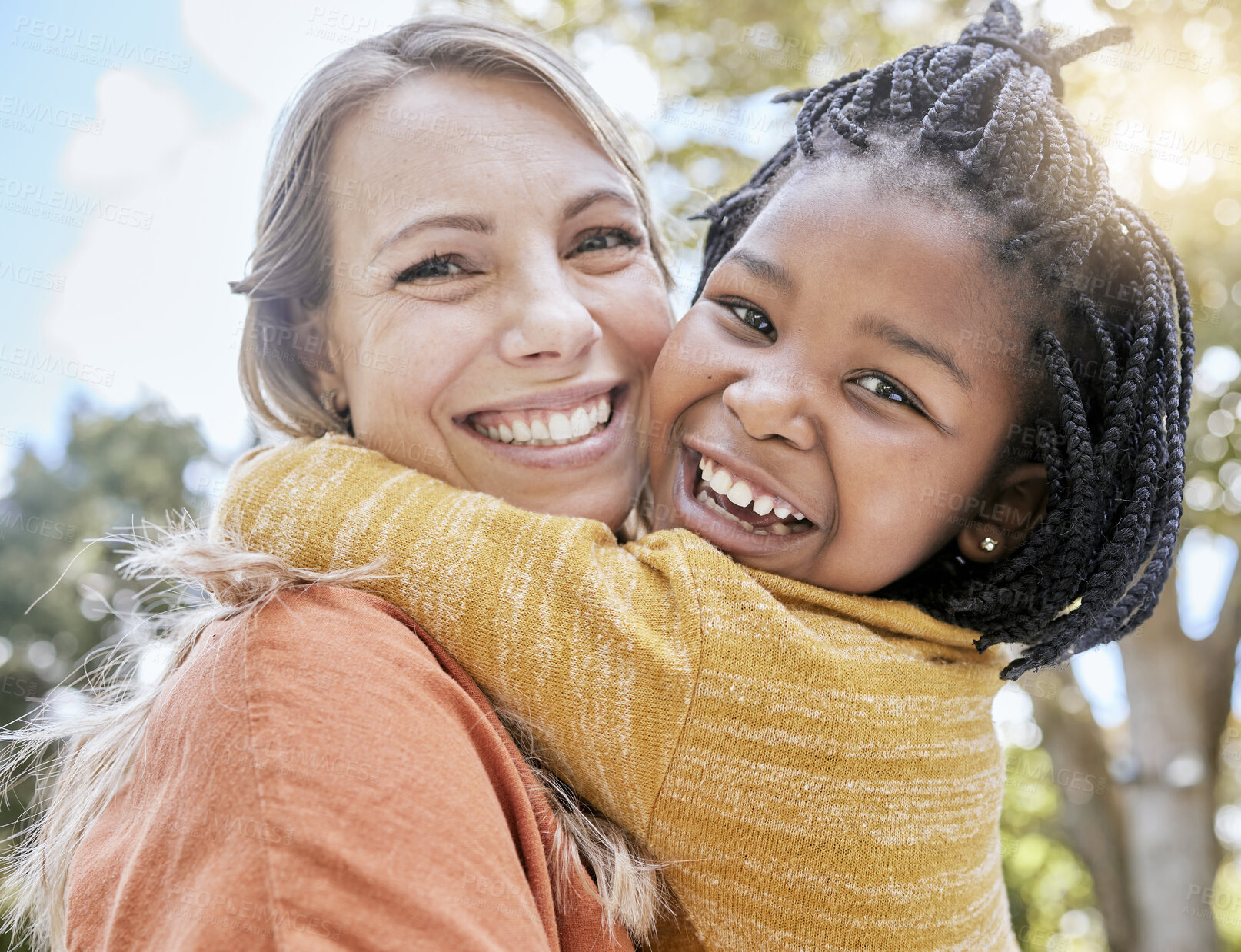 Buy stock photo Mom, child and interracial hug in park with smile, trees and sunshine in summer together for bonding. Mother, happy black child and outdoor embrace with love, care and diversity for happy family