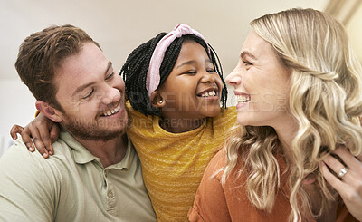 Buy stock photo Family diversity and adoption with a foster mother, father and girl bonding in the living room of their home. Trust, love and smile with a man, woman and daughter happy together in their house
