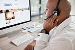 Call center, man and computer with online news advice for customer service communication. Hotline, operator and crm or contact us telemarketing agent talking on a helpline headset in contact center