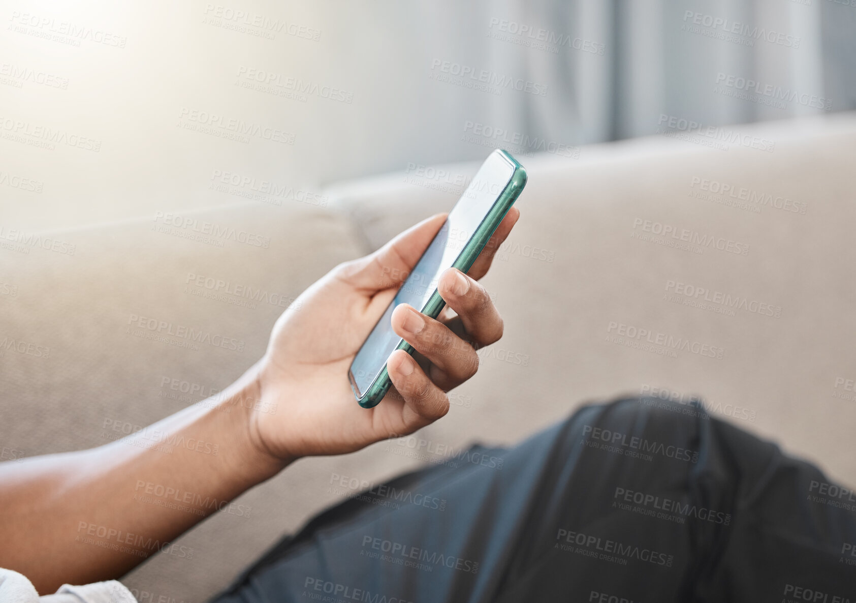 Buy stock photo Communication, online and hand typing on phone browsing internet, social media and network. Technology, communication and person relaxing on sofa at home on mobile app, texting and using smartphone