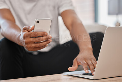 Buy stock photo Phone, laptop and man with 5g network for communication, cloud computing and information technology while at, home doing remote work. Hands of black man with smartphone for networking and research