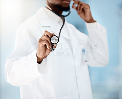 Doctor, cardiologist and stethoscope for healthcare of a medical, checkup for health and wellness in a hospital. Hand of black man listening to breathing and heart for cardiology and health insurance