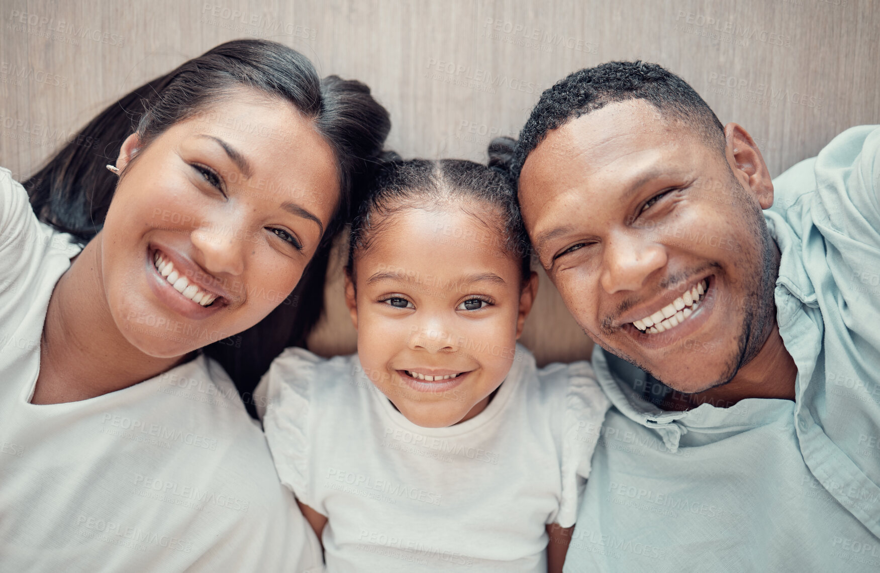 Buy stock photo Top view, faces or family bonding on floor in house living room or home bedroom in trust, love and support. Portrait, smile and happy man, woman and child or girl, kid and mother and father parents