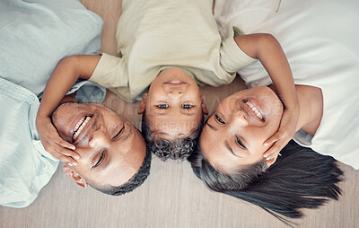 Buy stock photo Top view, family and boy bonding on floor in house living room or home bedroom for mothers day, fathers day or love. Portrait, smile and happy man, woman and child in trust, security and love support