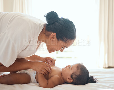 Buy stock photo Care, playful and mother with baby on the bed in the morning with a smile for happiness in their family home. Mothers day, love and mom playing with her girl child in a bedroom or nursery in a house
