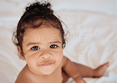 Buy stock photo Face, baby and portrait with a newborn infant girl sitting in a cot or crib in the bedroom of her home from above. Children, innocent and cute with an adorable little female kid in her house closeup