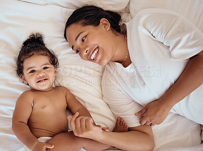 Buy stock photo Top view, mama and baby with smile, on bed and happy together for bonding, childhood and loving in home. Love, mom or toddler in bedroom, happiness or positive for wellness, tenderness and motherhood
